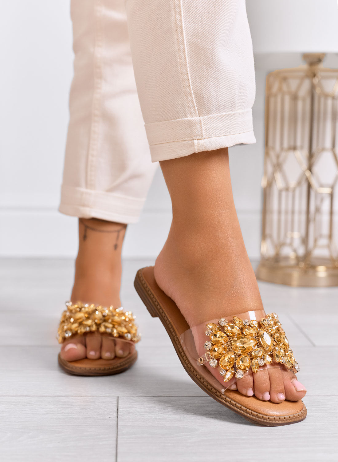 DAFFY - Transparent slide sandals with golden jewel embellishments