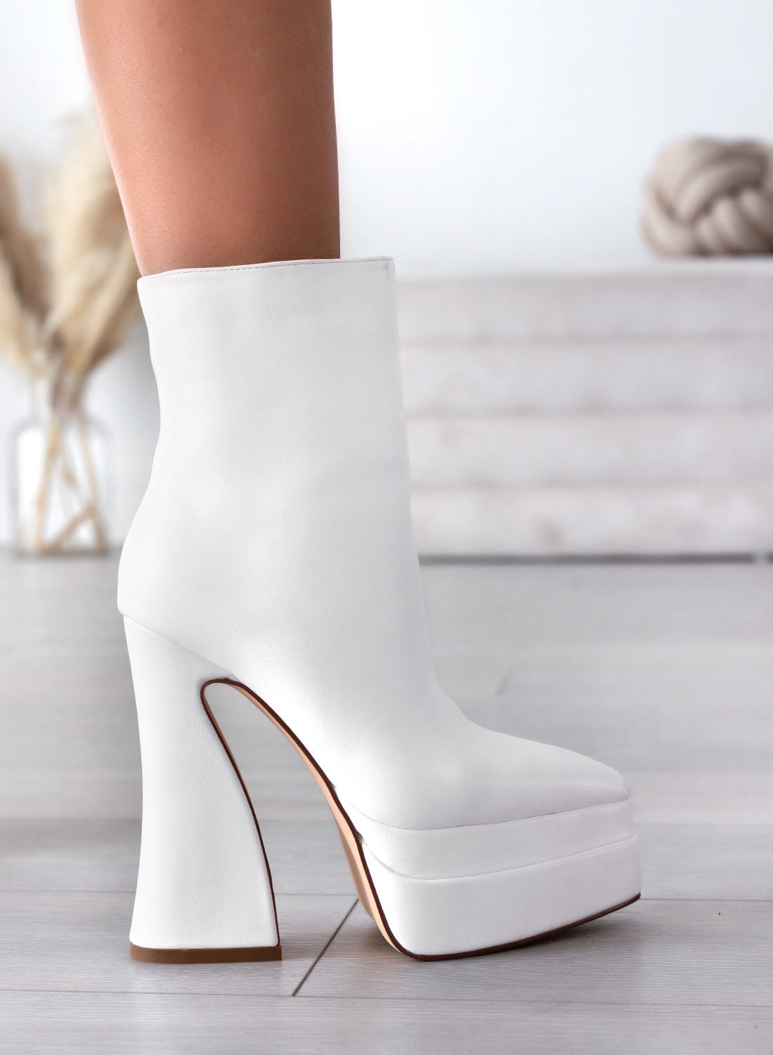 White Alexoo ankle boots with pointed toe and curved heel