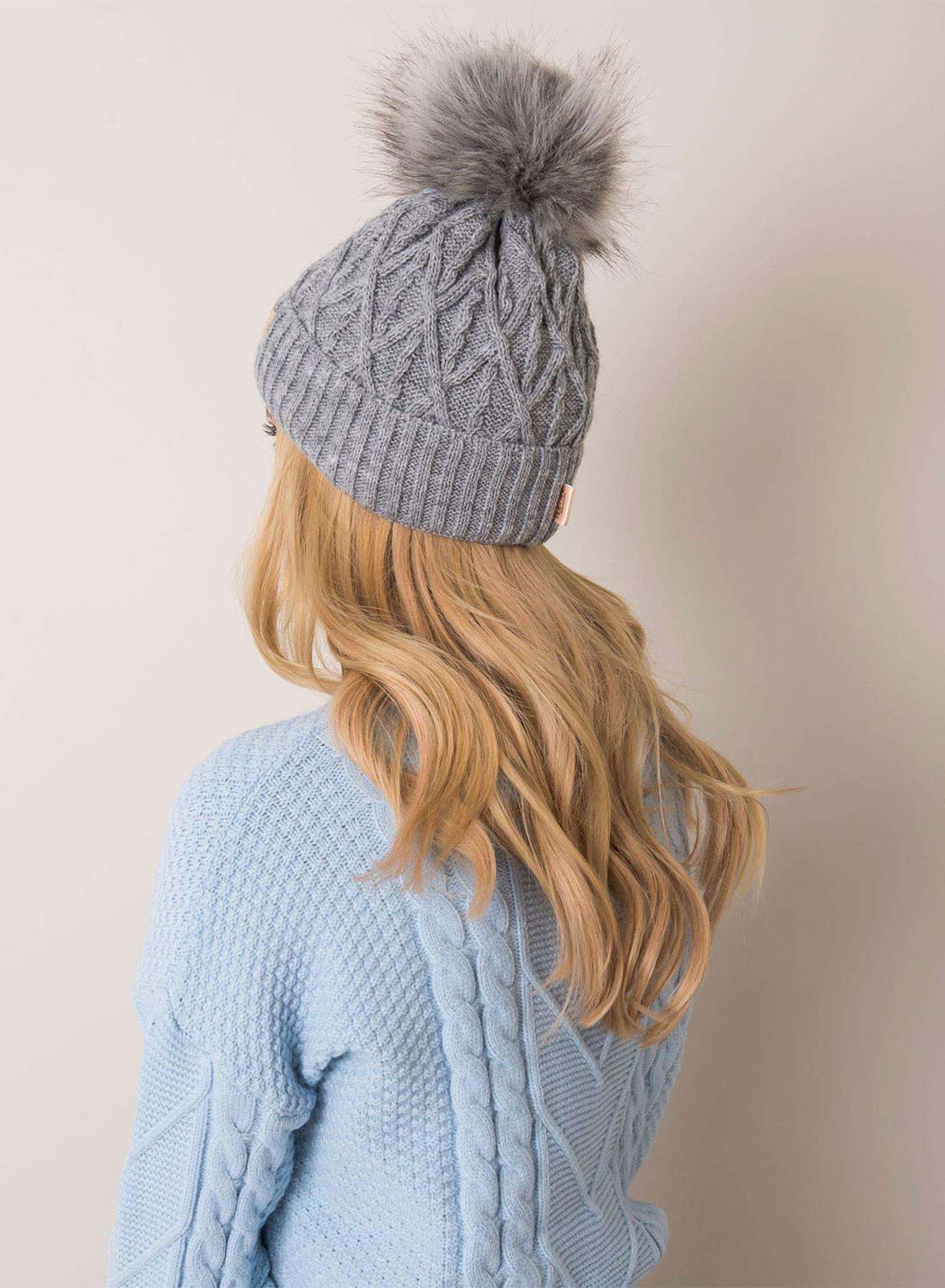 Padded gray hat with faux fur pompom