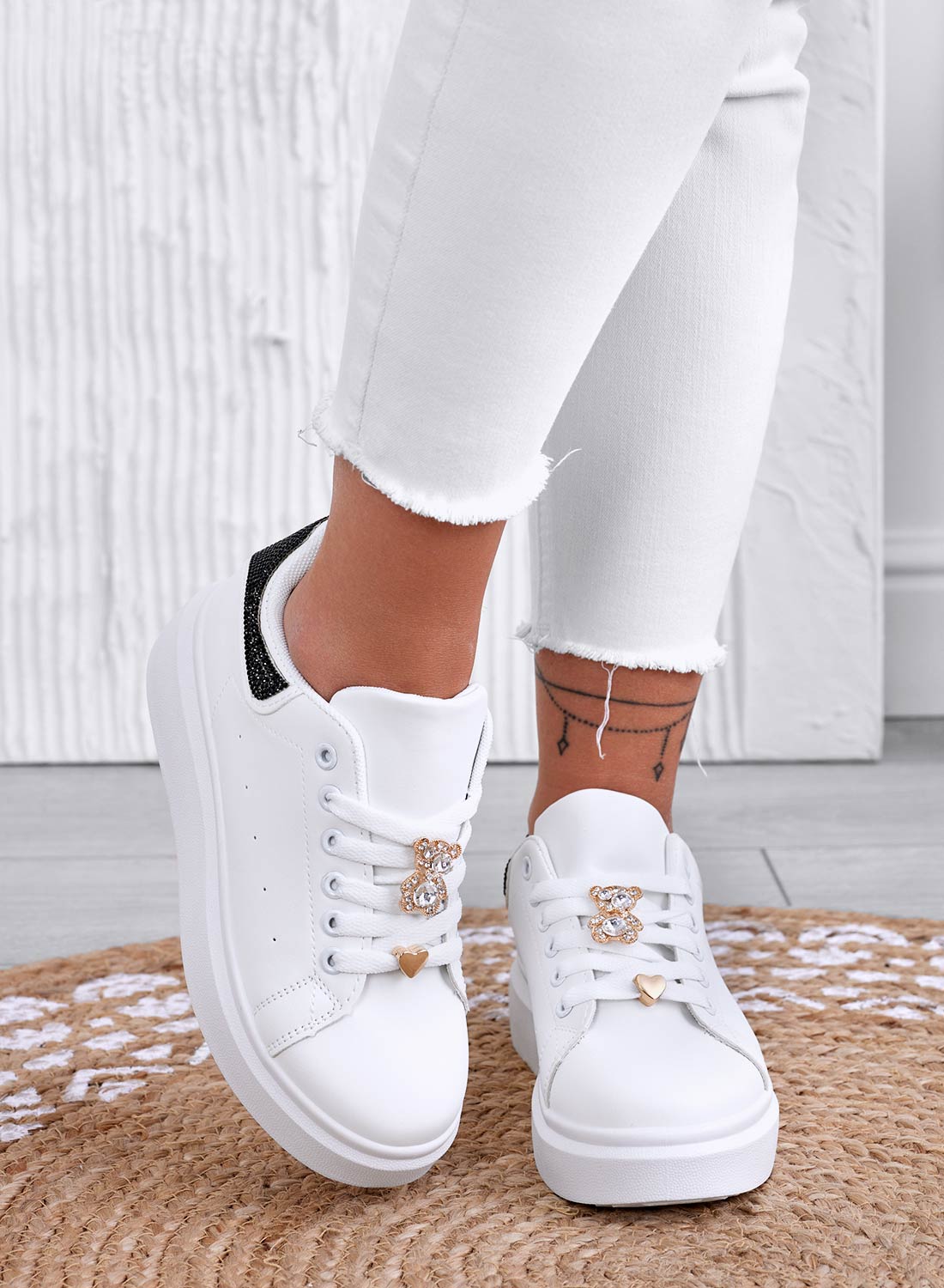 White sneakers with jewel appliqué and black rhinestone heel
