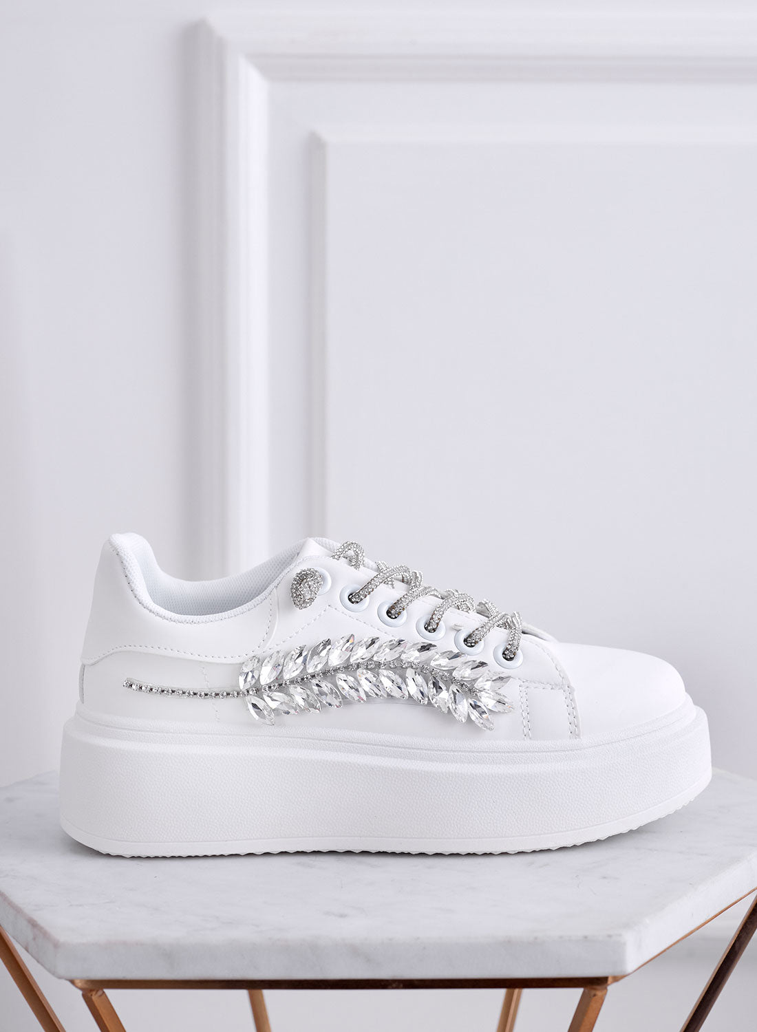 White sneakers with jewel embellishments