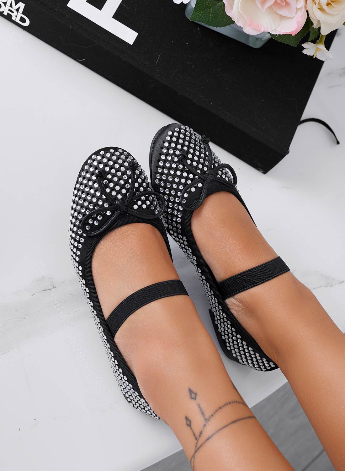 Black jeweled ballet flats with bow