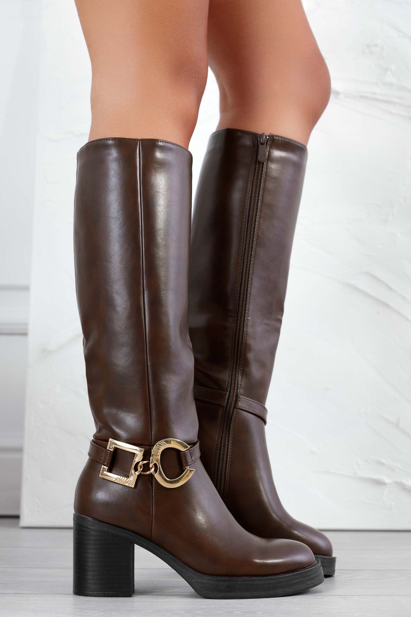 Brown boots with gold embellishments