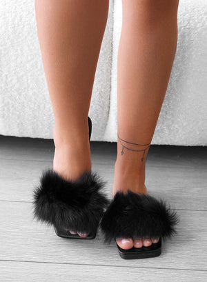Black slip-on sandals with faux fur