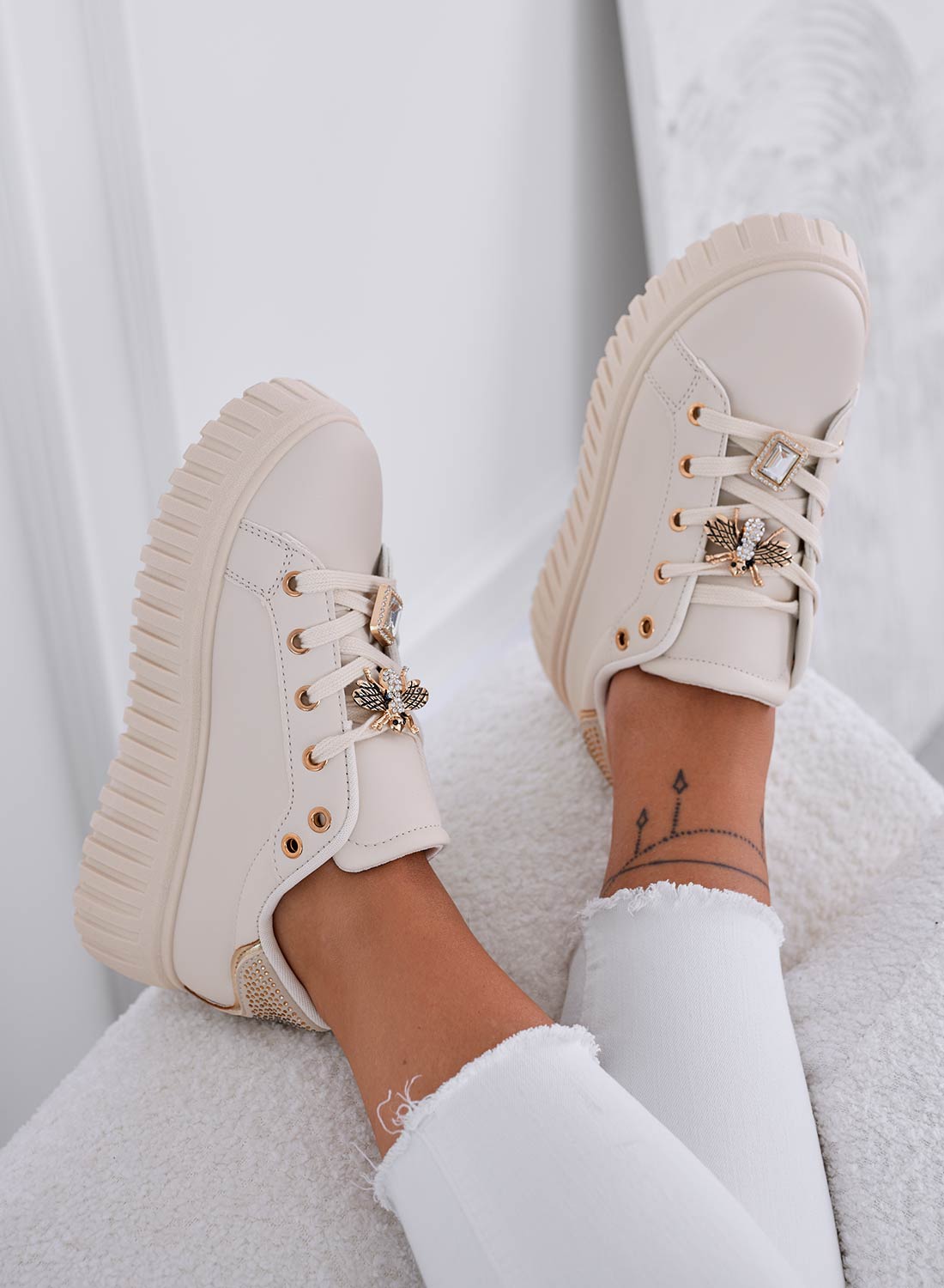 Beige sneakers with jeweled bee embellishment