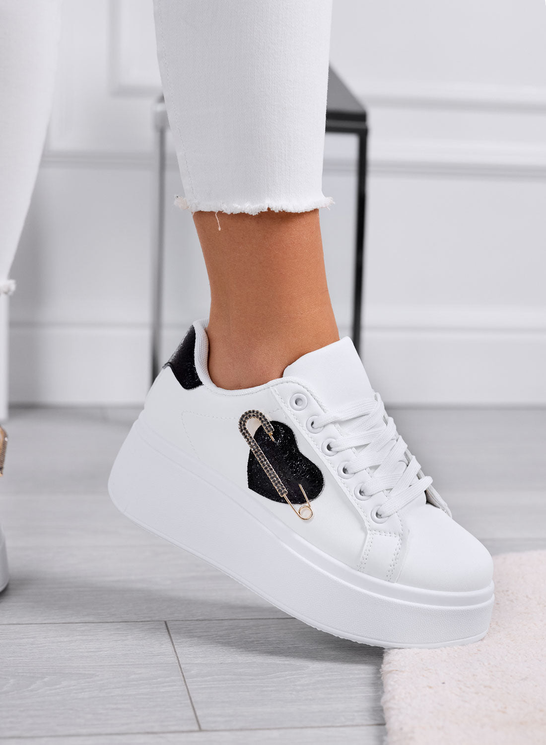 White platform sneakers with jeweled brooch embellishment