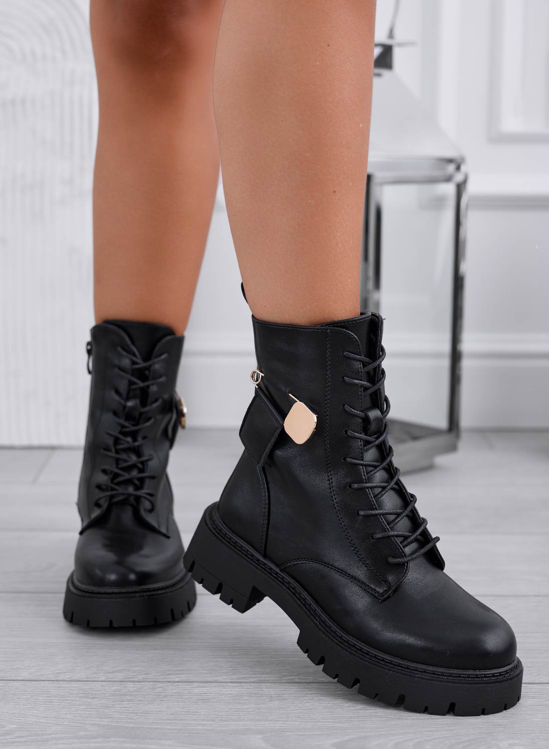 Black ankle boots with gold brooch