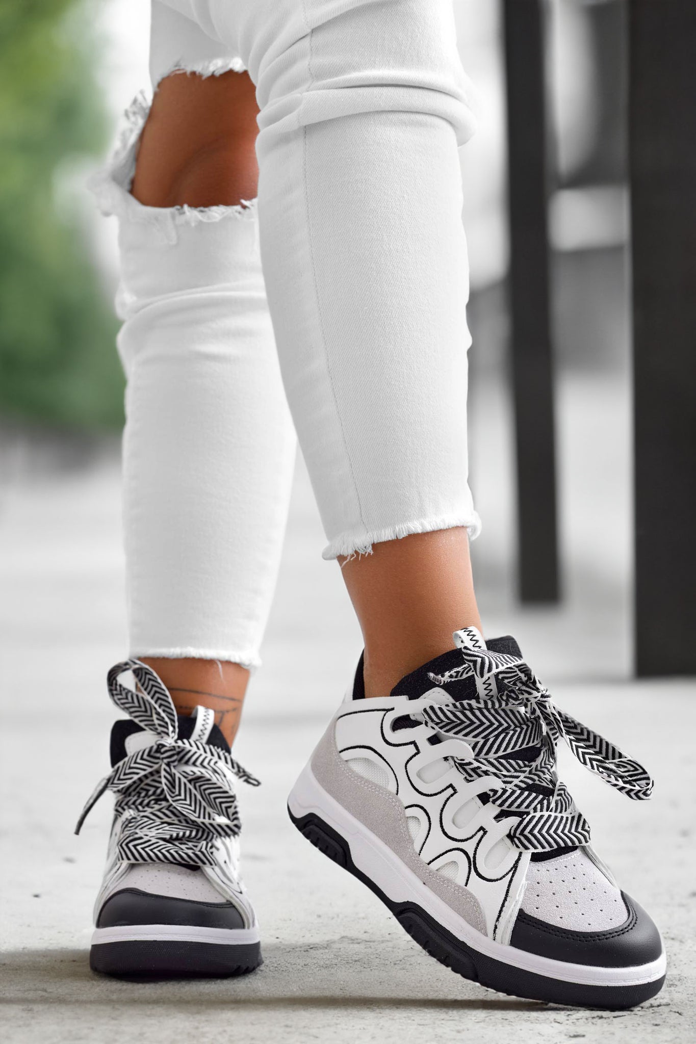 White sneakers with contrasting black panels