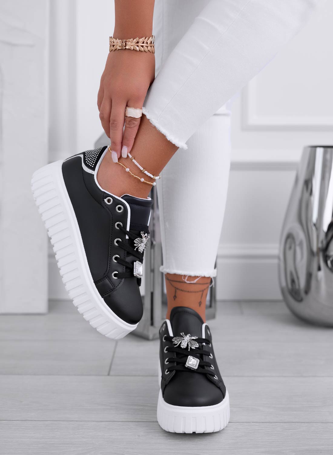 Black sneakers with gold bee jewel embellishment