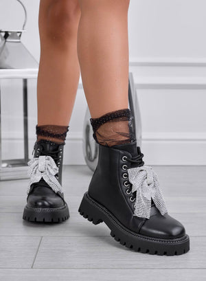 Black combat boots with jeweled bow