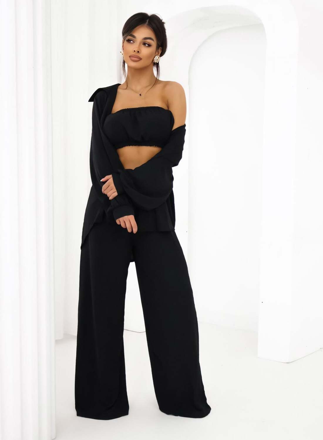Three-piece black set consisting of shirt, top, and trousers
