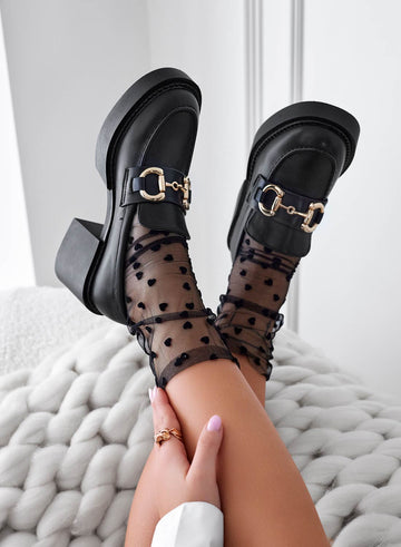 Black platform loafers with gold buckle