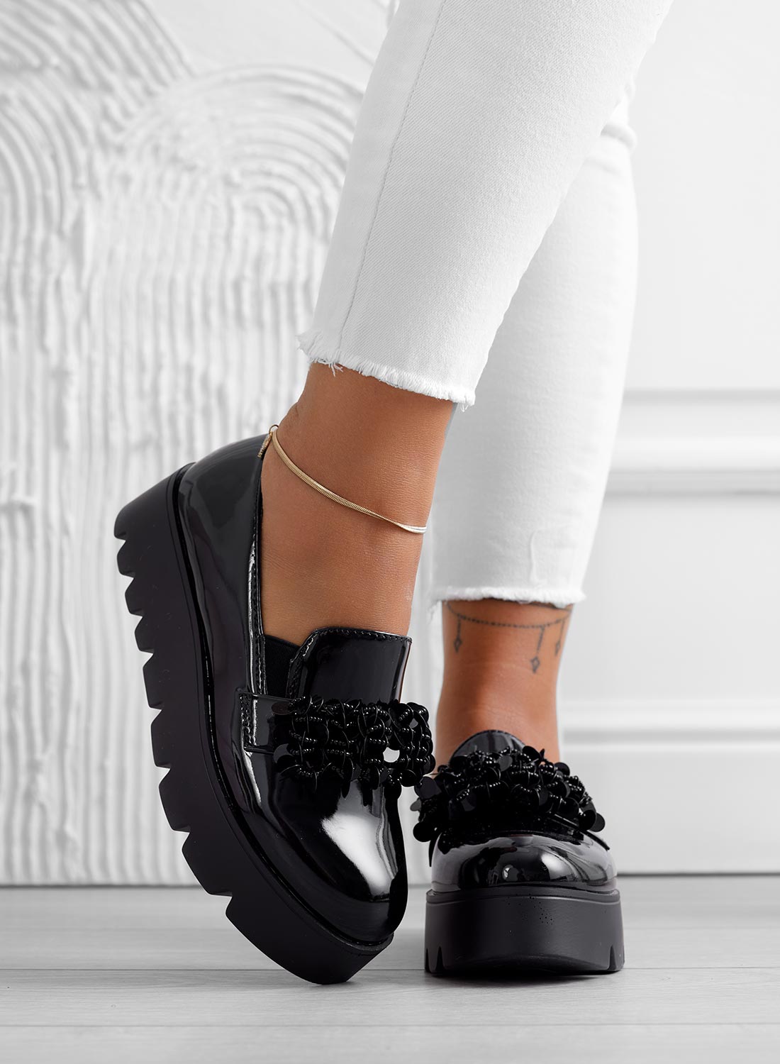 Black patent loafers with embellishments
