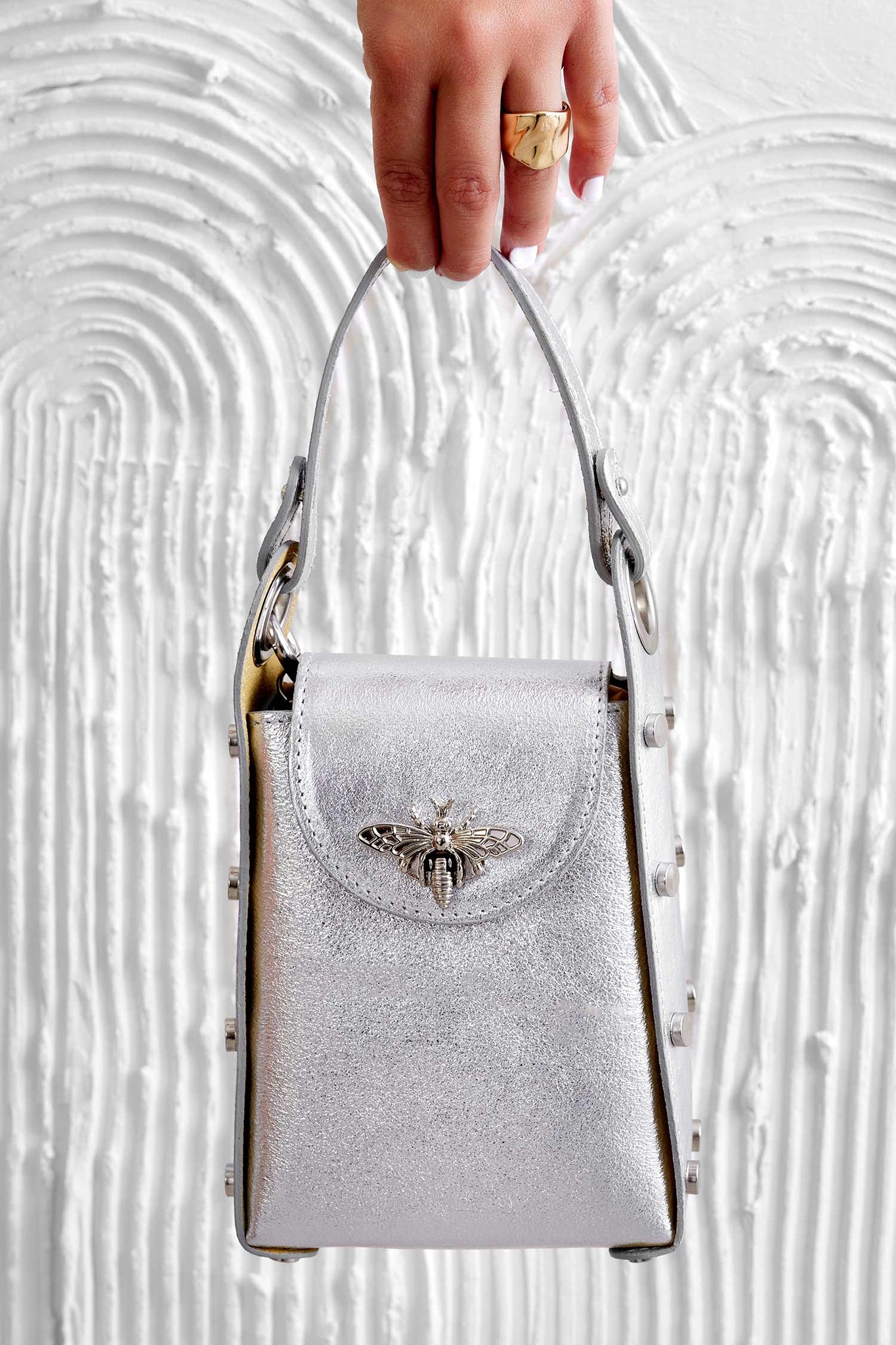 Metallic silver handbag with studs and removable shoulder strap