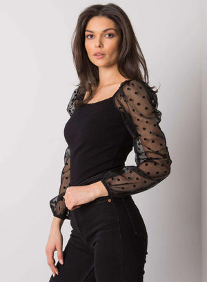 Black top with sheer sleeves and polka dots