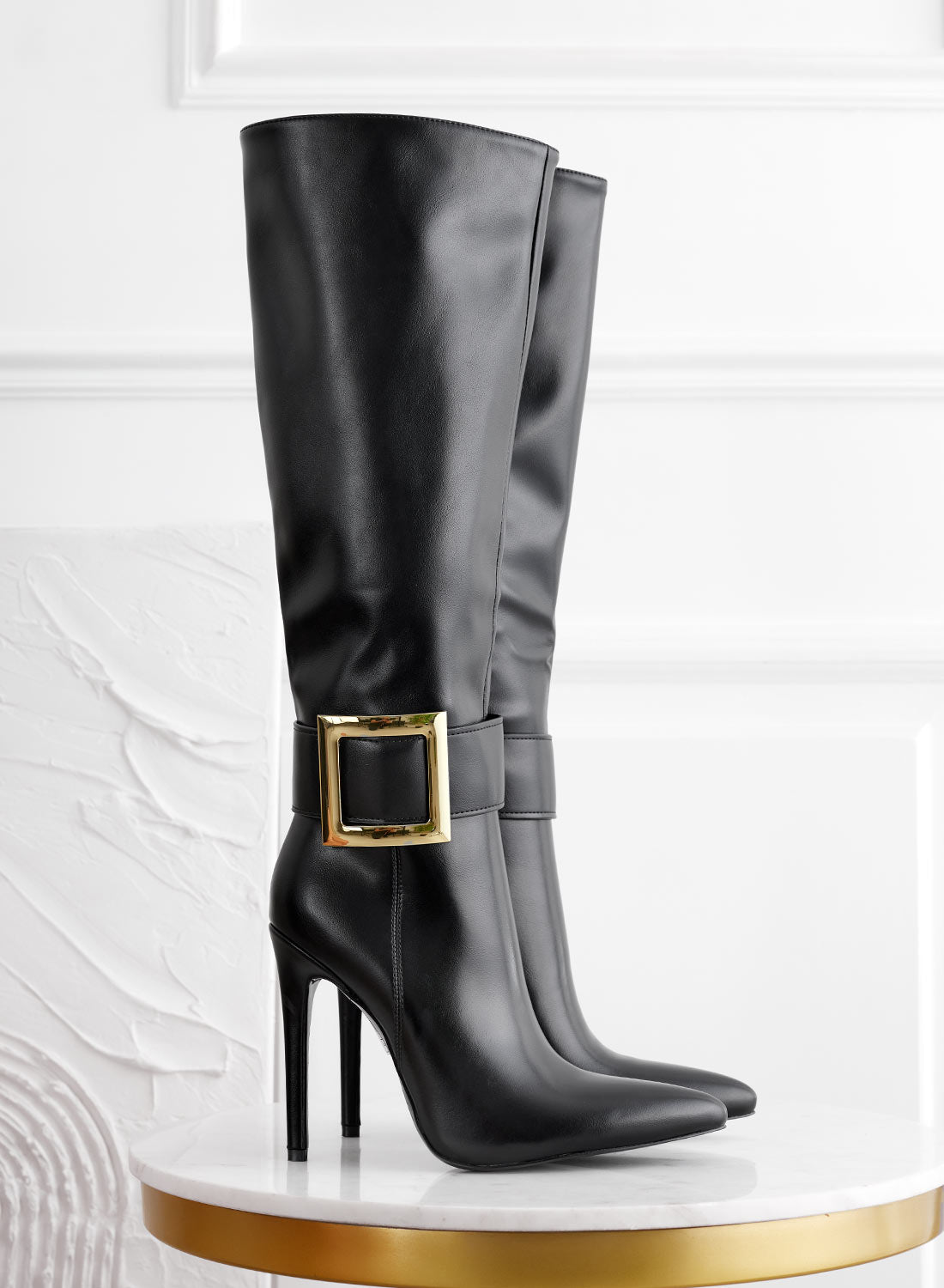 Black boots with gold buckle and high stiletto heel