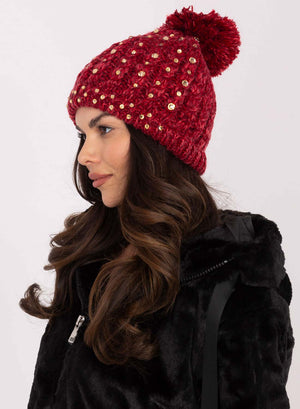 Red padded hat with rhinestones and pompom