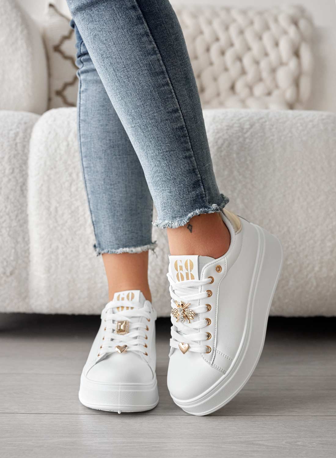 White sneakers with jewel appliqués and gold heel