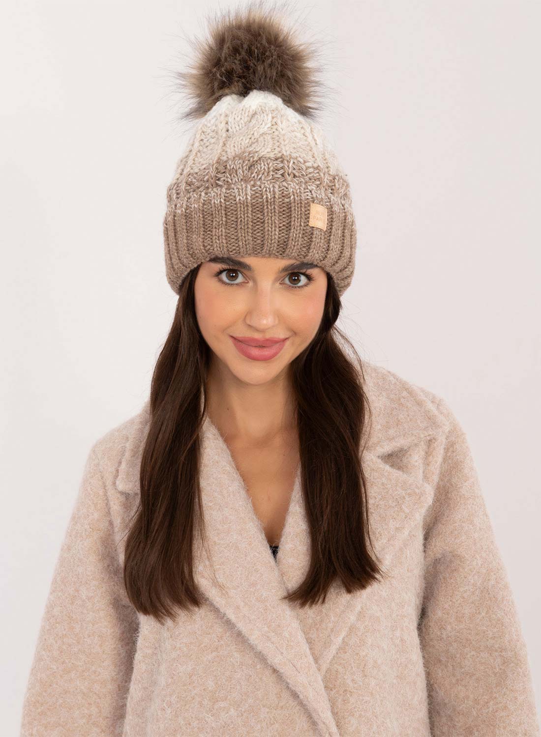 Mud-colored hat with inner padding and pompom