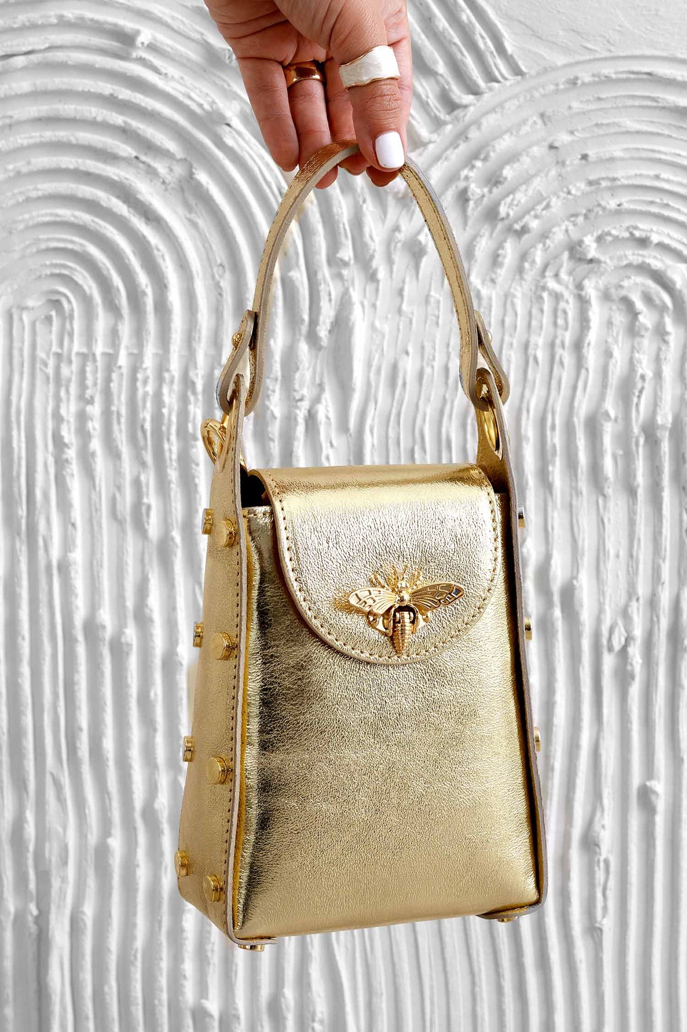 Metallic gold handbag with studs and removable shoulder strap