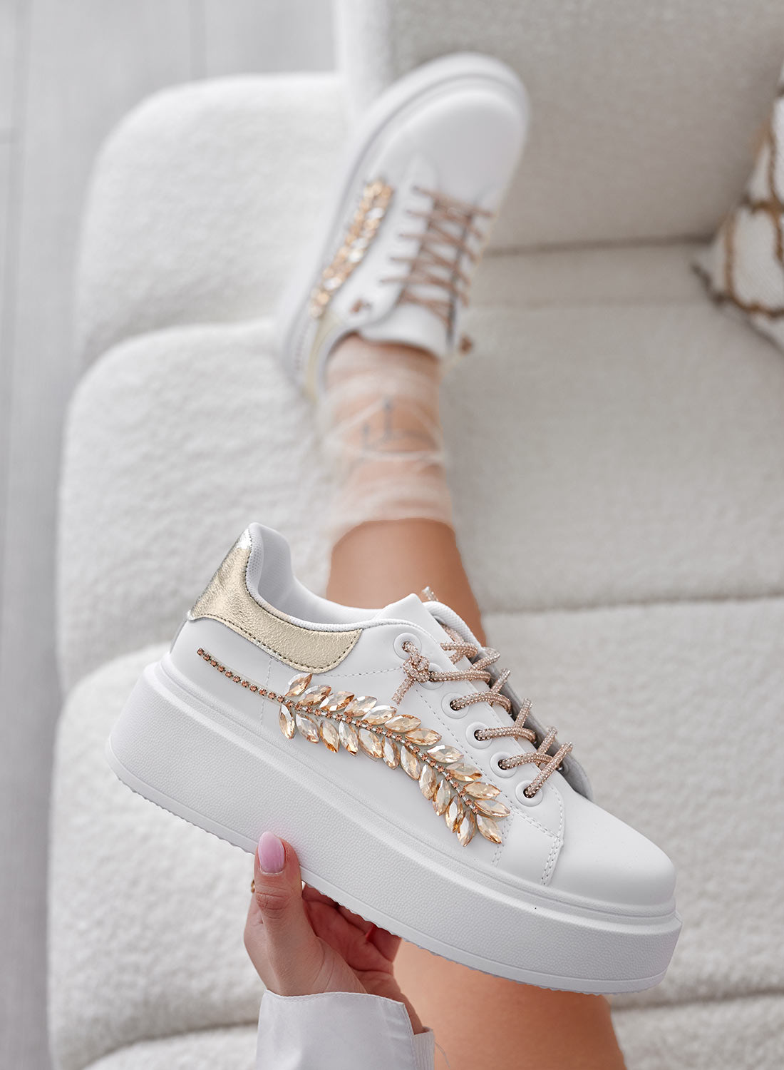 White sneakers with gold jewel embellishments