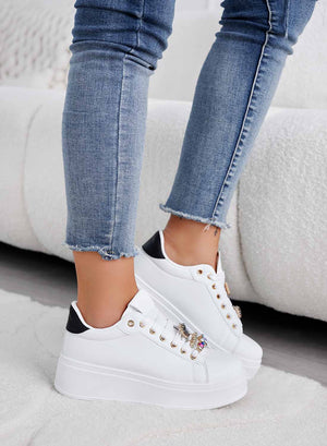 White sneakers with black heel and jewel embellishments
