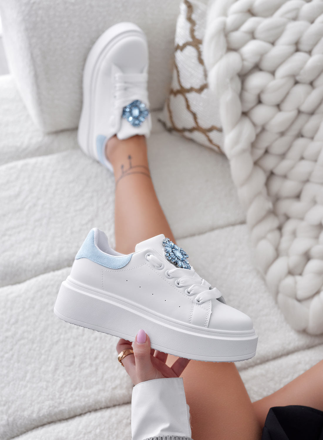 White sneakers with light blue heel and jewel