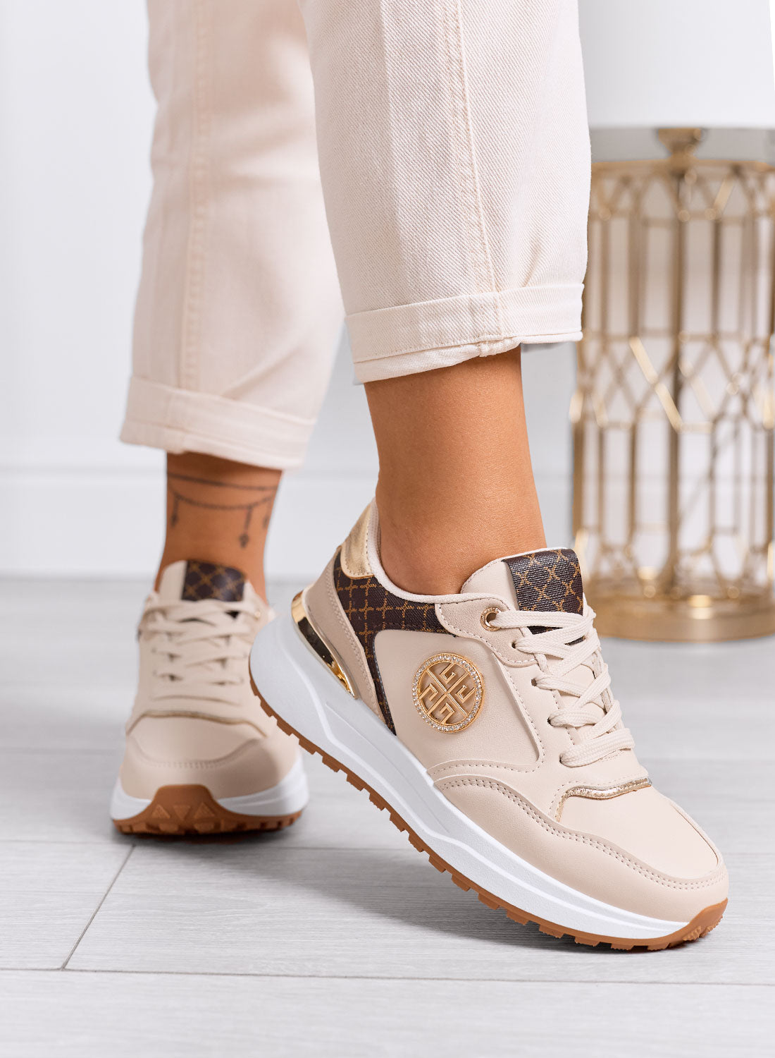 GLAMY - Beige sneakers with gold details and monogram print