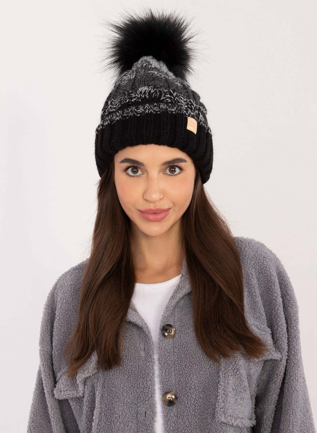 Black hat with inner padding and pompom