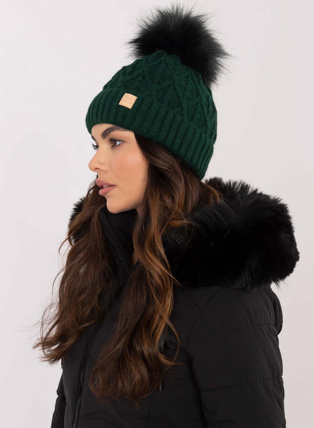 Green padded hat with faux fur pompom