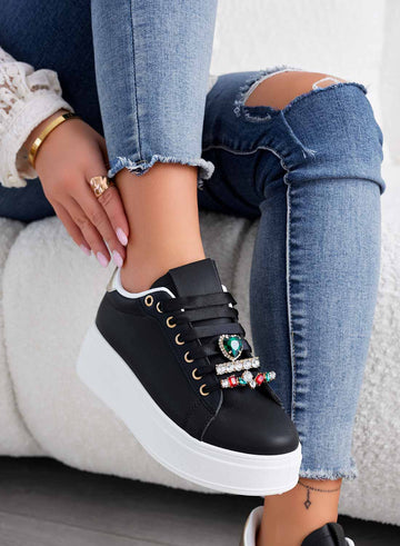 Black sneakers with green jewel embellishments