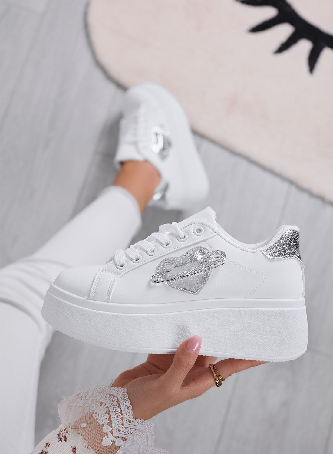White platform sneakers with silver jewel brooch embellishment