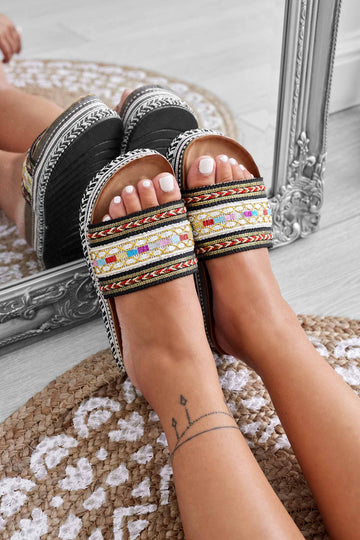 Black slip-on sandals with multicolor pattern