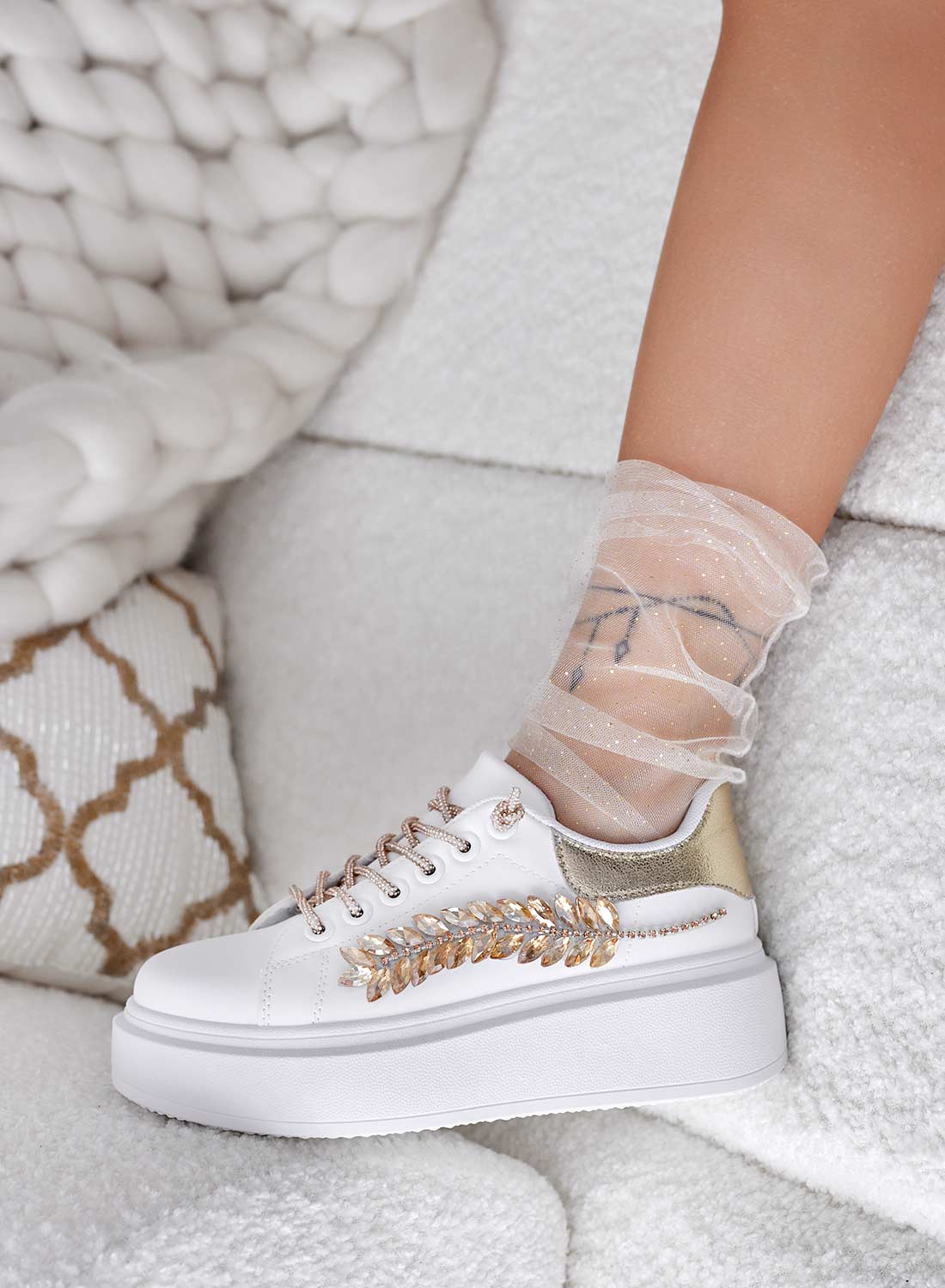 White sneakers with gold jewel embellishments