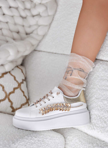 White sneakers with gold jewel embellishments