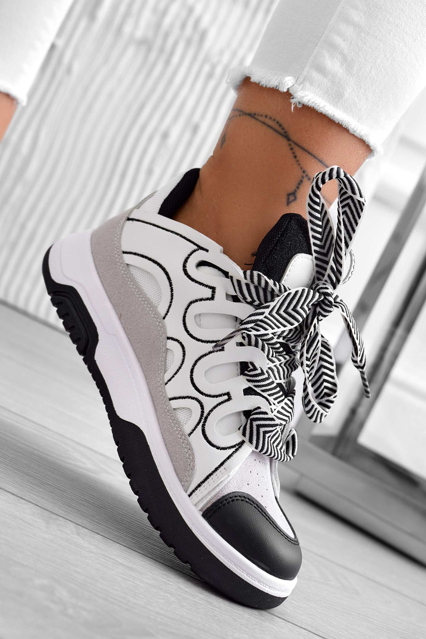 White sneakers with contrasting black panels