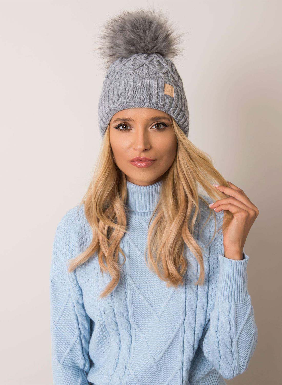 Padded gray hat with faux fur pompom