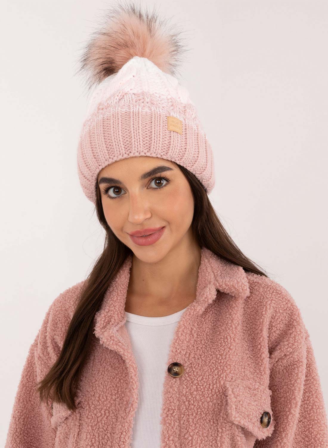 Pink hat with inner padding and pompom