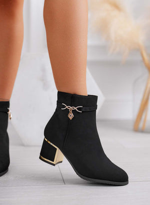 Black ankle boots with gold charm
