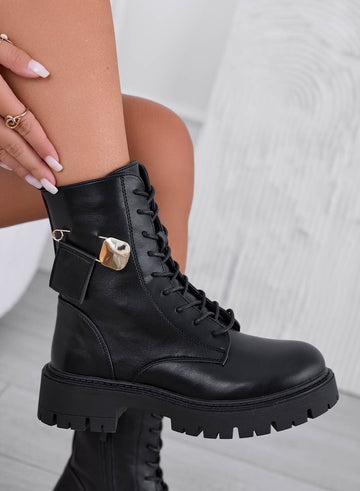 Black ankle boots with gold brooch