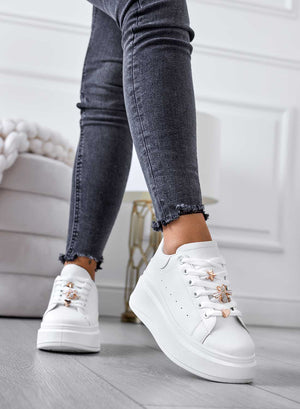 White sneakers with gold details and wedge heel