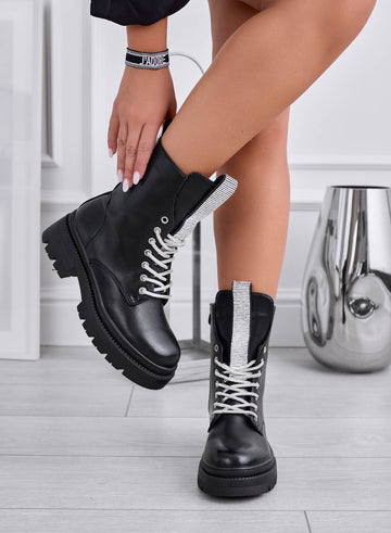 FILE - Black ankle boots with rhinestone laces