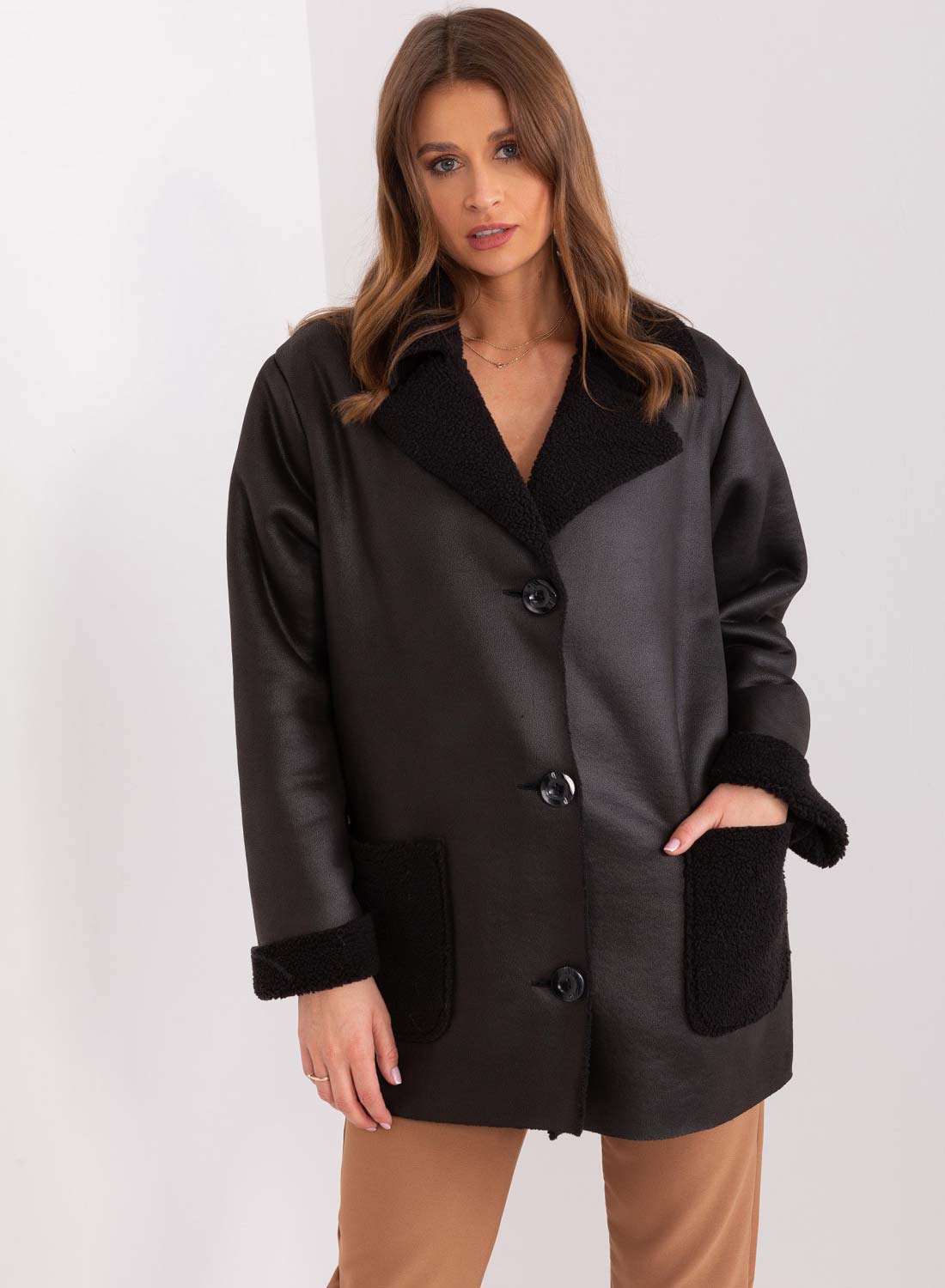 Giacca nera in montone oversize con tasche a contrasto