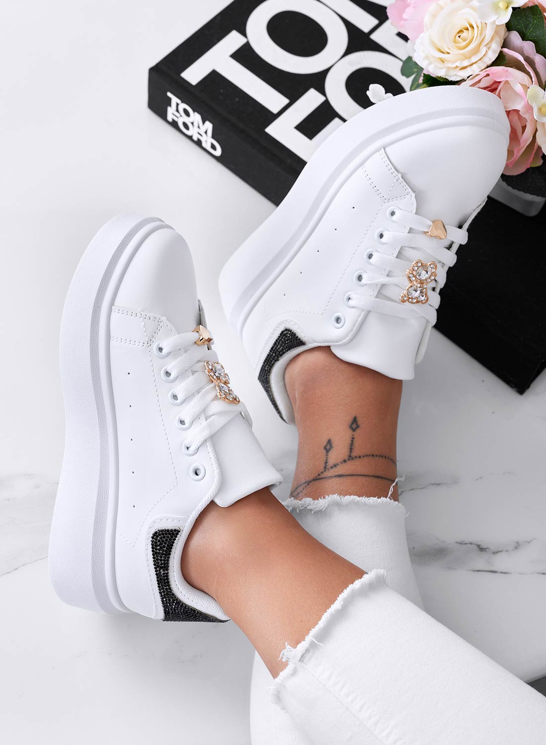 White sneakers with jewel appliqué and black rhinestone heel