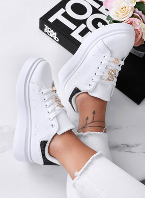 White sneakers with jewel appliqué and black rhinestone heel