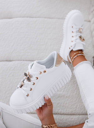 White sneakers with gold bee jewel embellishment