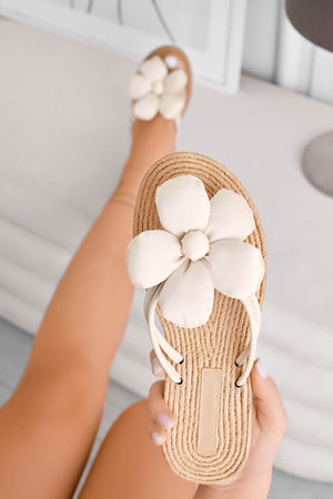 Beige flat flip-flop sandals with applied flower