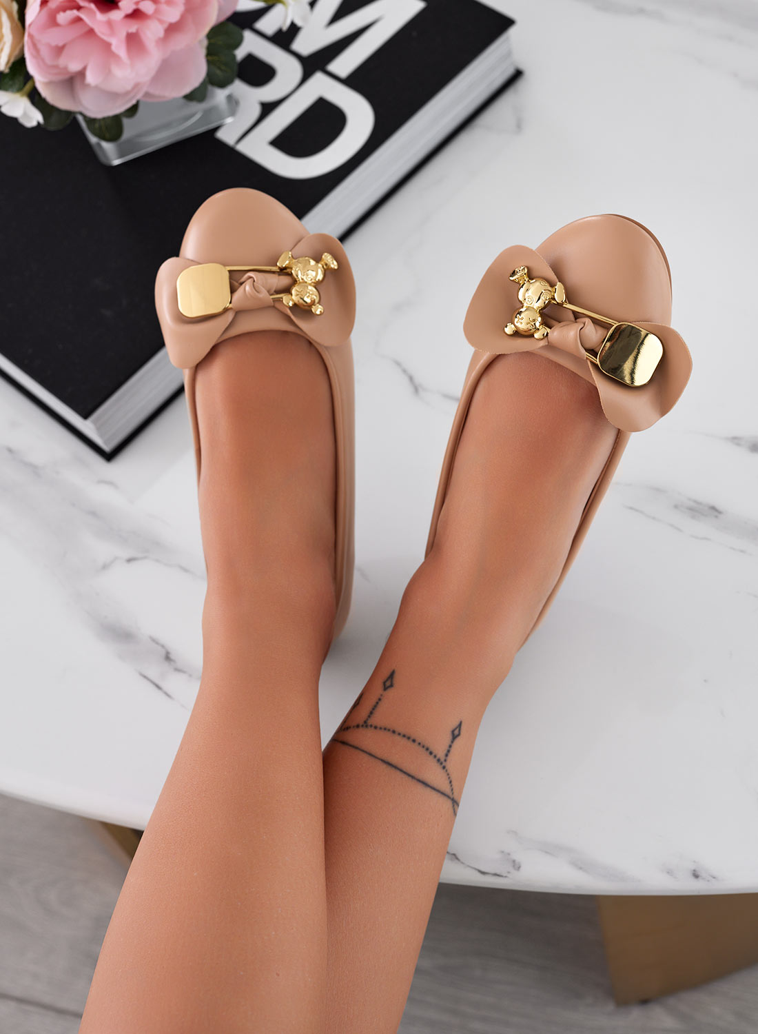 Beige ballet flats with gold teddy brooch