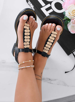 Black flat thong sandals with gold embellishment
