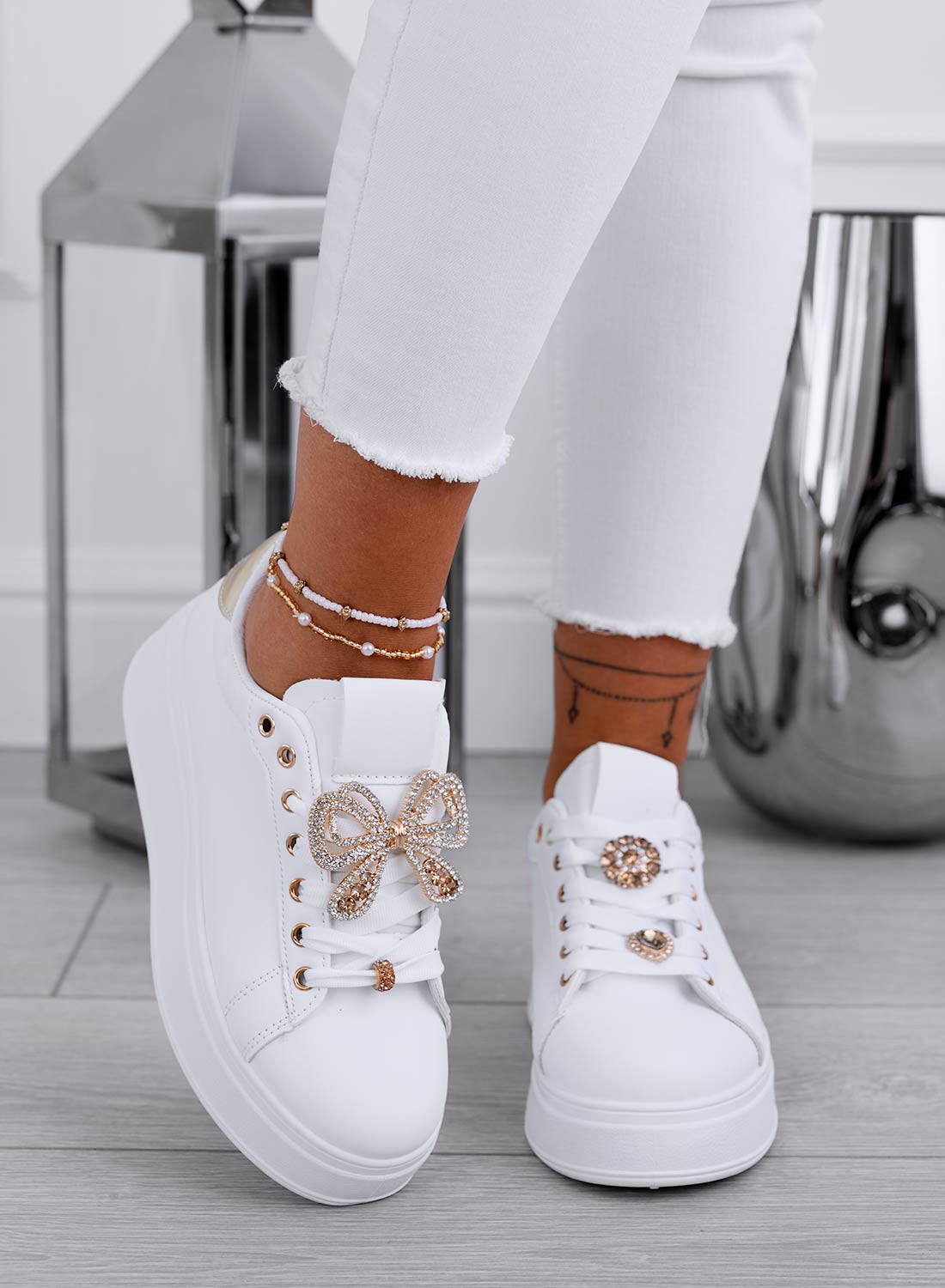 White sneakers with gold jewel bow